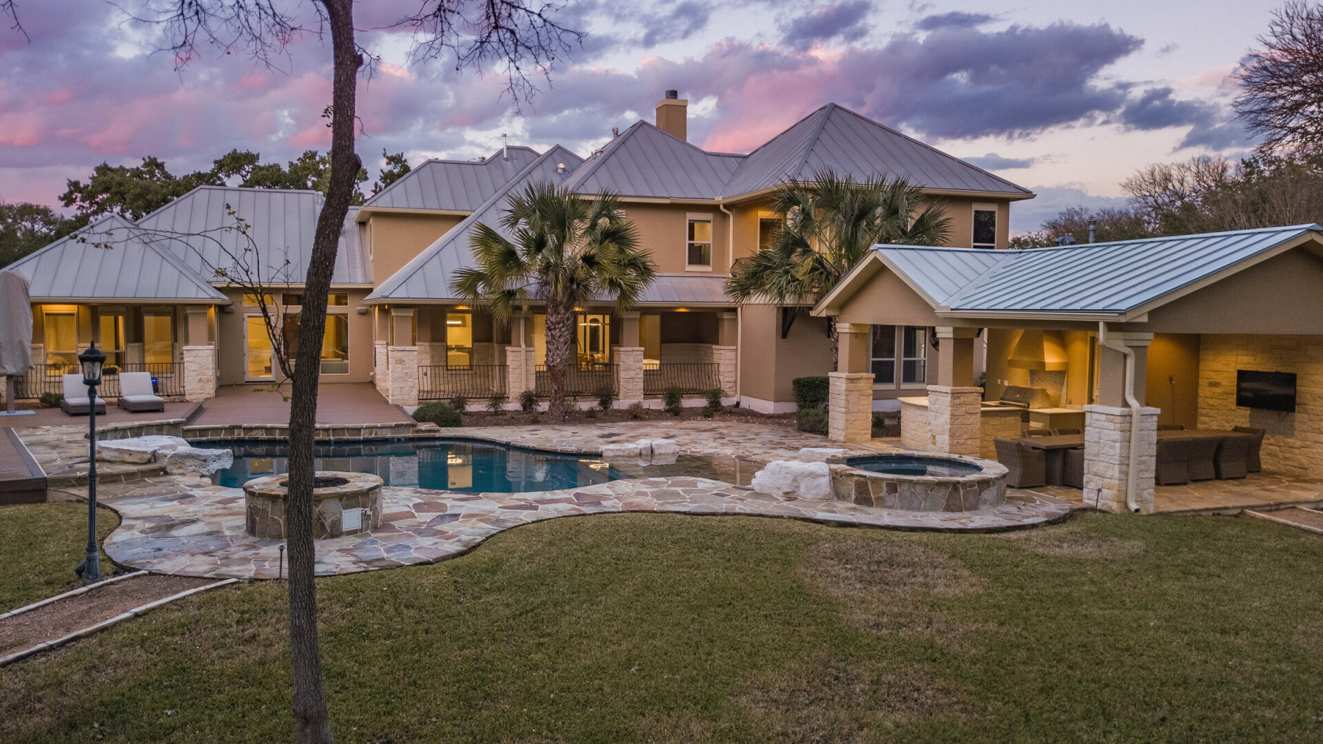Rear view of a transitional custom home at sunset, San Antonio TX